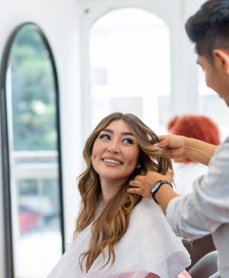 woman-smiling-while-talking-with-her-hairdresser-JWSDURH